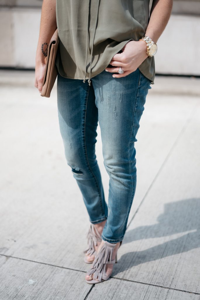 When transitioning from summer to fall with jeans it's important to mix different pieces that can balance each other. Mixing jeans with sleeveless tops and open toed shoes help keep your fall look light and airy.  Click through to see more tips! 