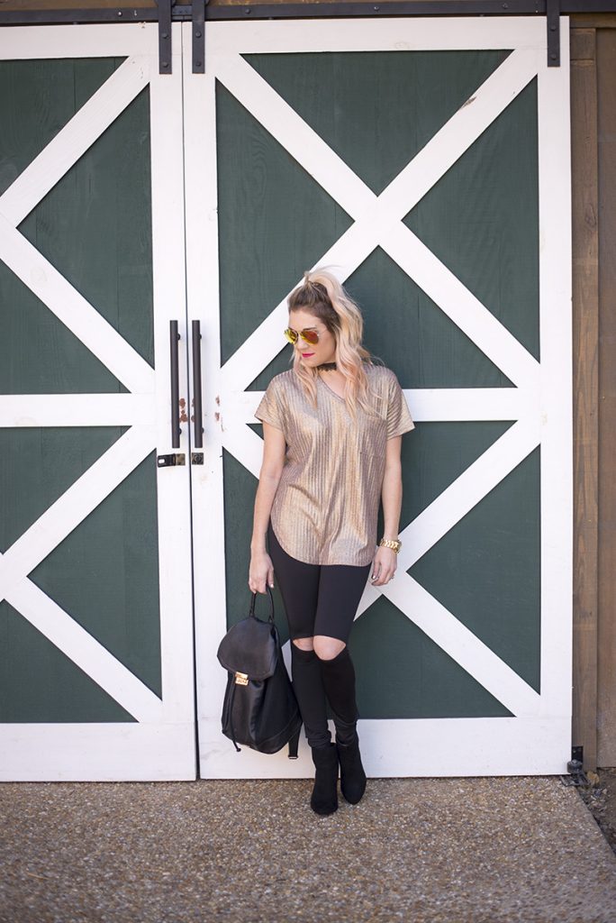 New Years Eve Looks: Casual featuring a sparkly gold top, black cutout leggings and black booties. Minimum jewelry with a black lace choker and gold watch. 