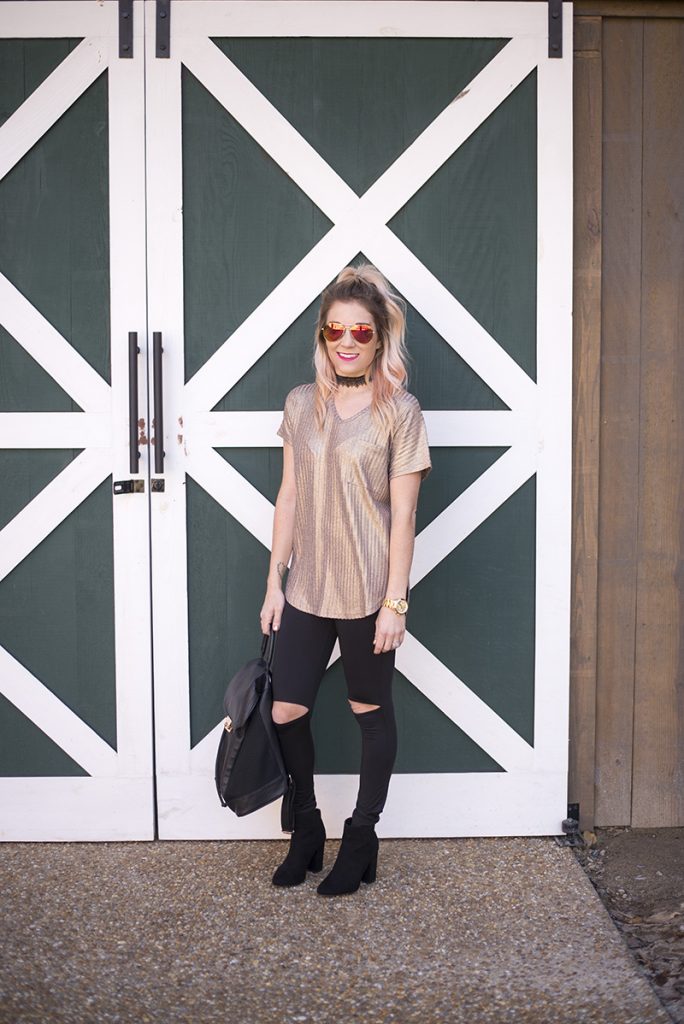 New Years Eve Looks: Casual featuring a sparkly gold top, black cutout leggings and black booties. Minimum jewelry with a black lace choker and gold watch. 