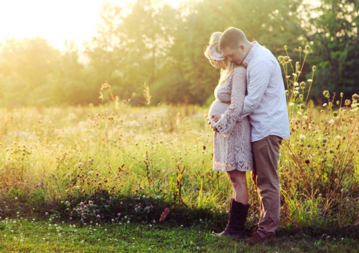 maternity photos in field at the golden hour