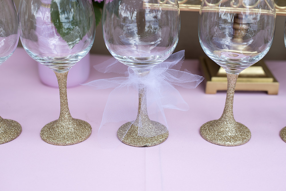 How to throw the perfect pink and gold bridal shower. Everything from DIY Glitter Wine glasses to a wine bar! 