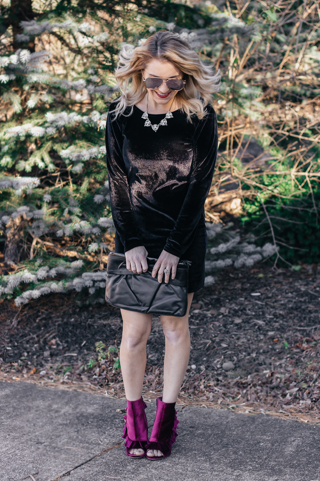 Holiday style in a black velvet dress and plum ruffled velvet shoes. 